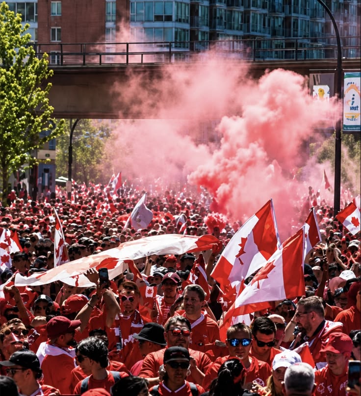 Illustrative street crowd carrying Canadian flags amid coloured smoke